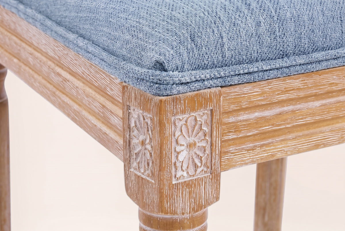 Close-up of a carved rosette corner block, the reeded seat rail, a turned front leg and the Denim Blue seat edge