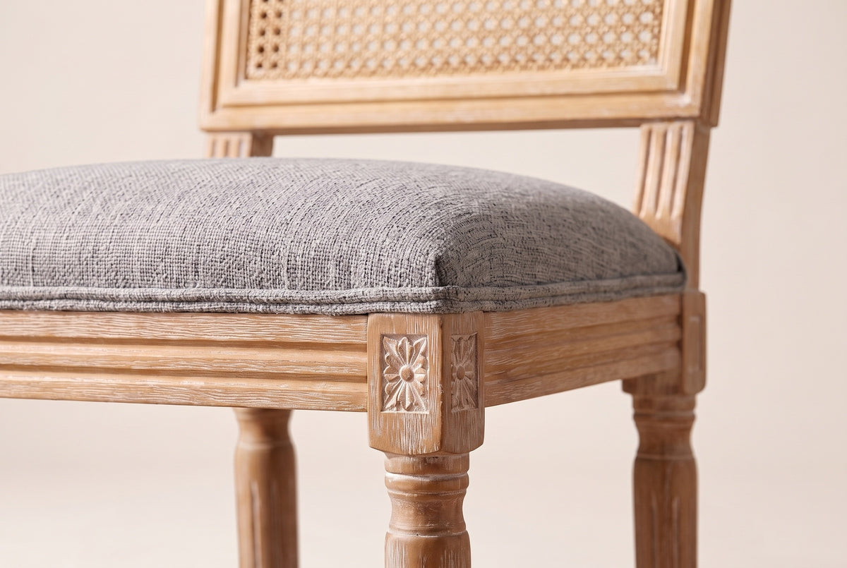 Close-up of the Mid Grey linen-look seat, the reeded rail and the carved rosette on a front corner block
