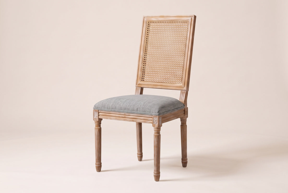Castelfranco French cane-back dining chair in Mid Grey, three-quarter view on a warm off-white backdrop