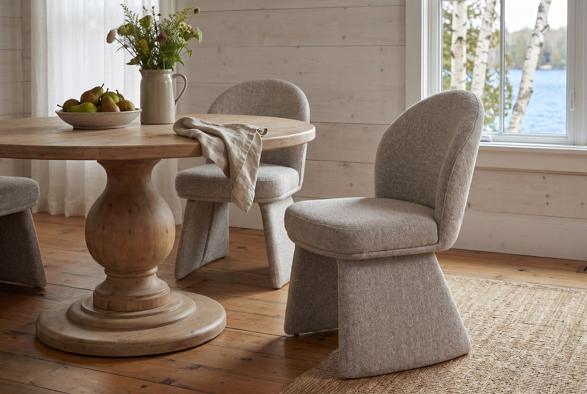 Castellabate dining chairs in beige around a round pine pedestal table in a whitewashed Muskoka cottage