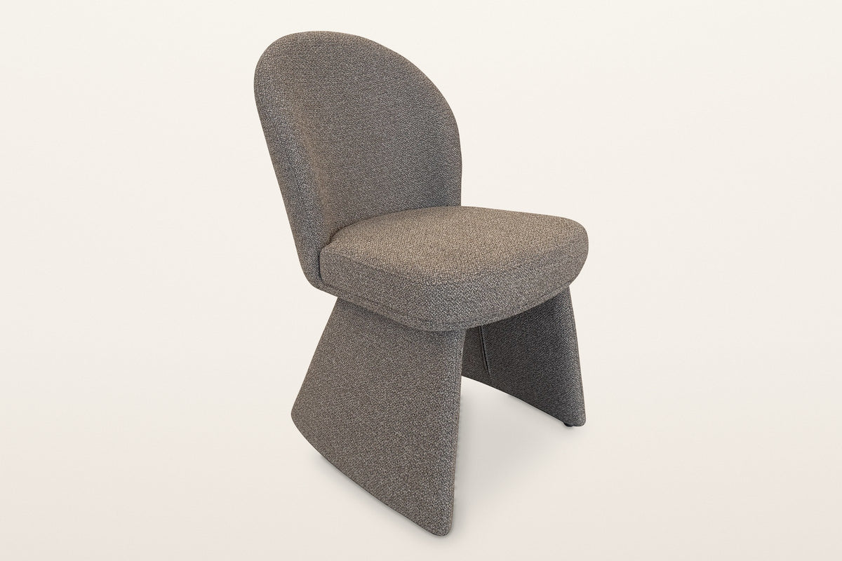 Castellabate sculpted boucle dining chair in brown, three-quarter view on a warm white studio backdrop