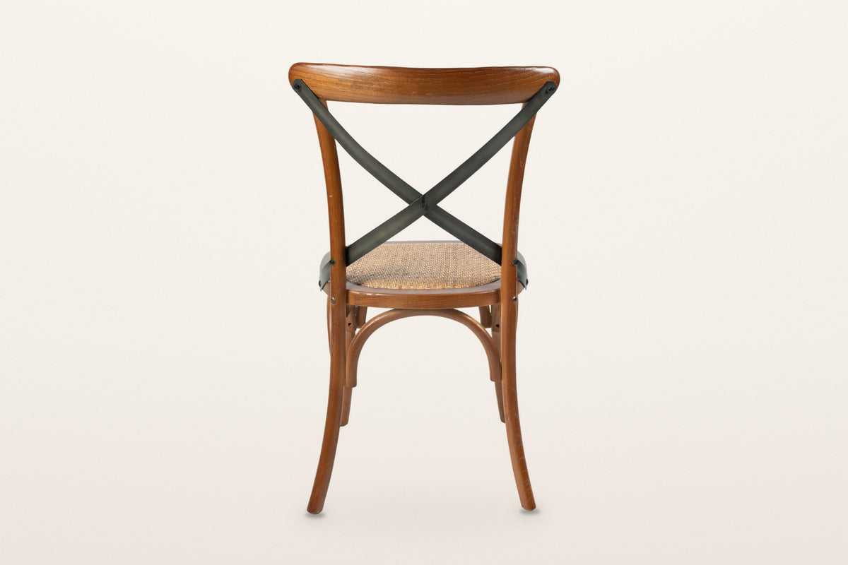The back of the Castelmola dining chair in Brown on a warm white studio backdrop