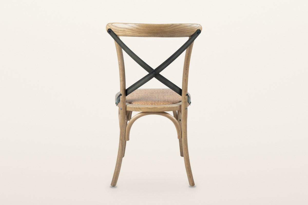 The back of the Castelmola dining chair in Natural Rustic on a warm white studio backdrop
