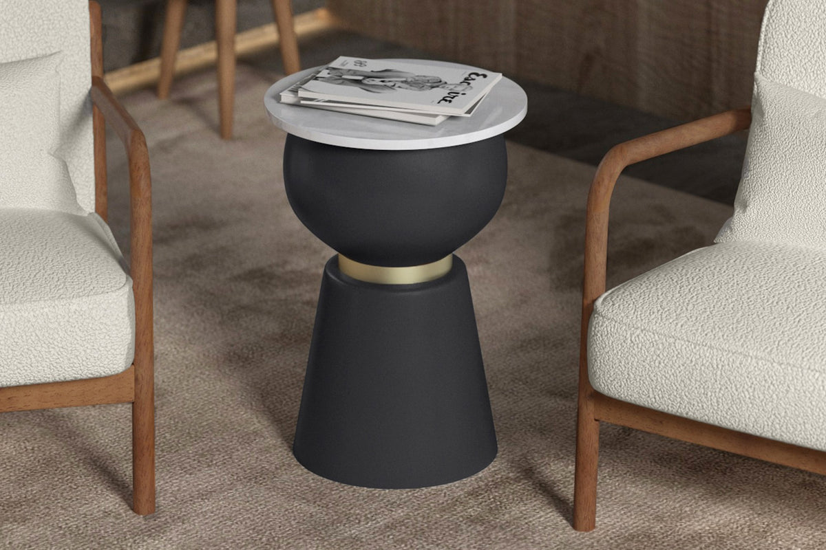 Celeste marble and black iron side table with magazines between two cream lounge chairs