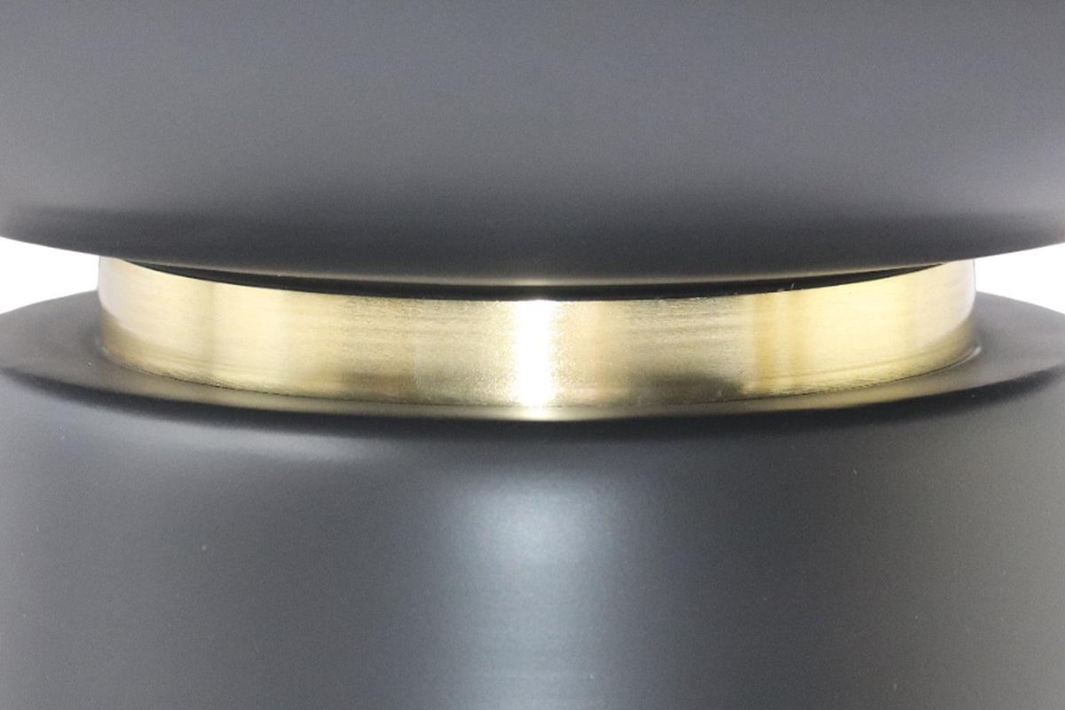 Close-up of the Celeste brushed gold band between the black iron bowl and base