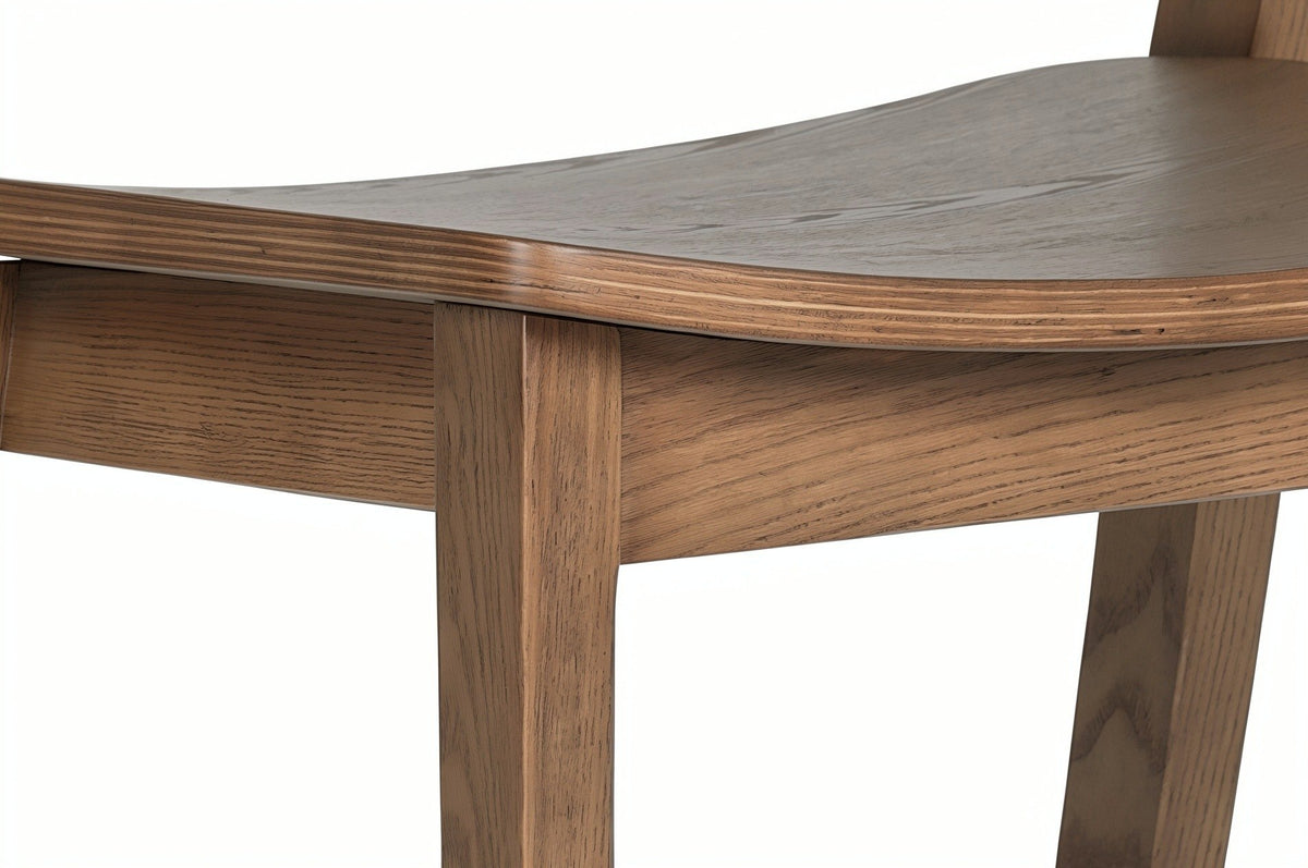 Close-up of a Certosa front leg in walnut where the two seat rails meet it under the layered seat edge