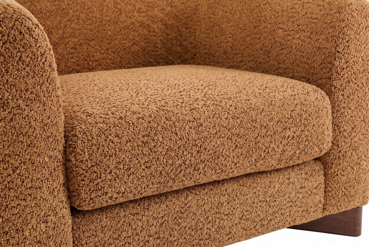 Close-up of the Caramel boucle on the Cervia seat cushion and arm