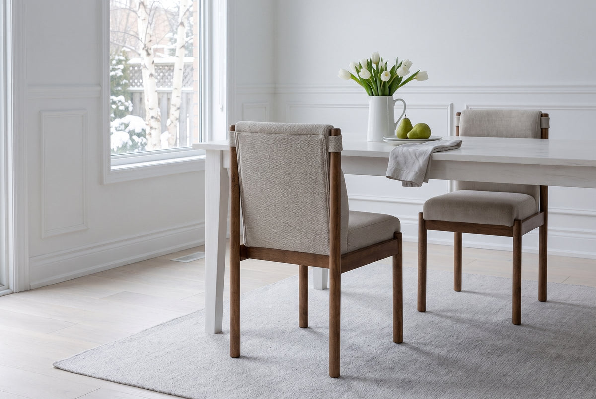 Cervo dining chair in beige and walnut from behind at a white table in an Ottawa dining room