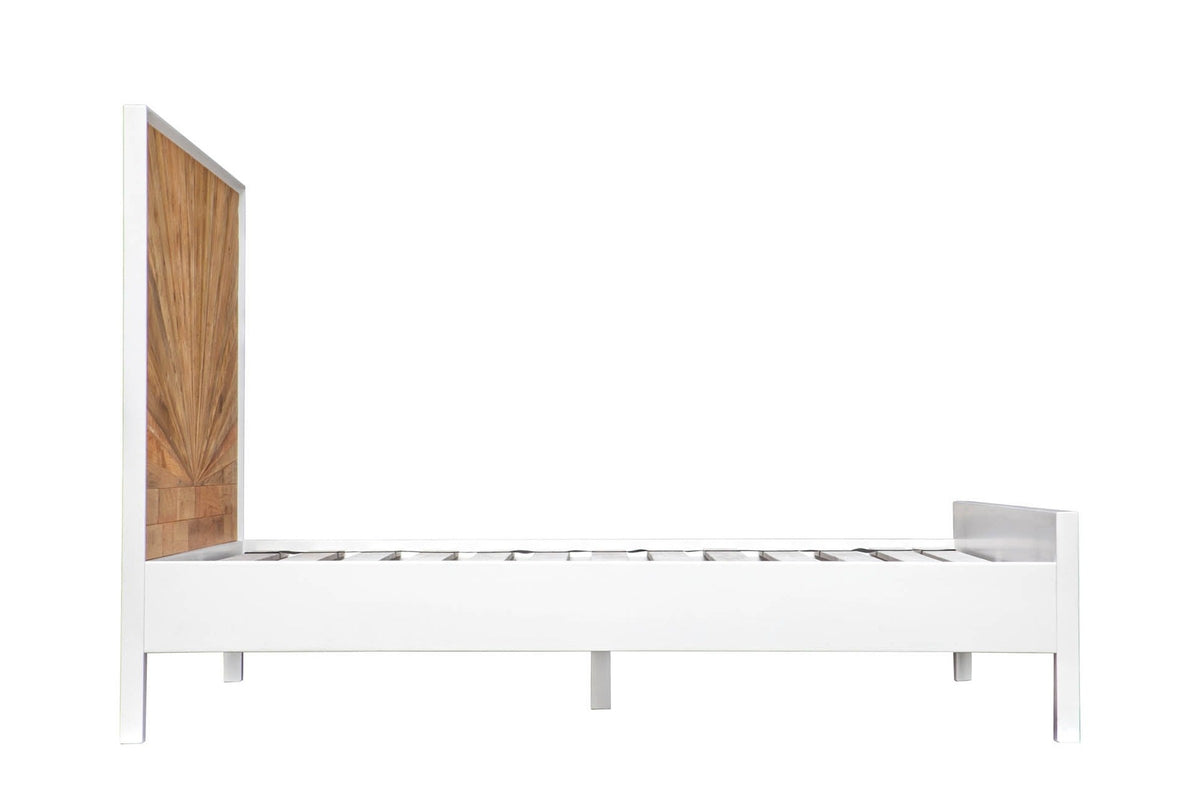 The Cesana bed from the side: the tall pine headboard, the plain white rail on square legs and the low footboard