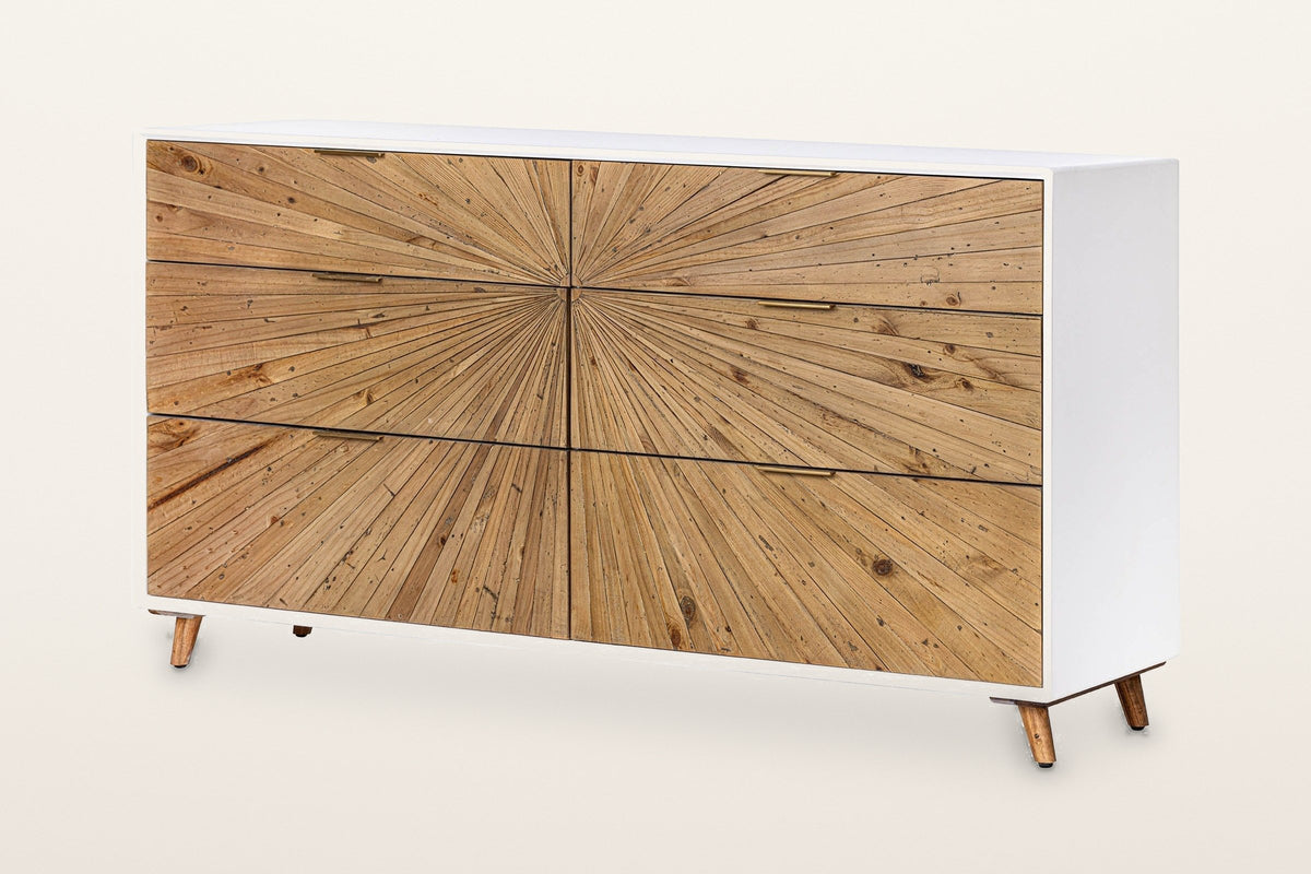 Cesana 63 in 6-drawer dresser: a sunburst of natural reclaimed pine strips across six drawers in a white lacquer case, slim brass pulls, four splayed legs, three-quarter view on a warm white studio backdrop