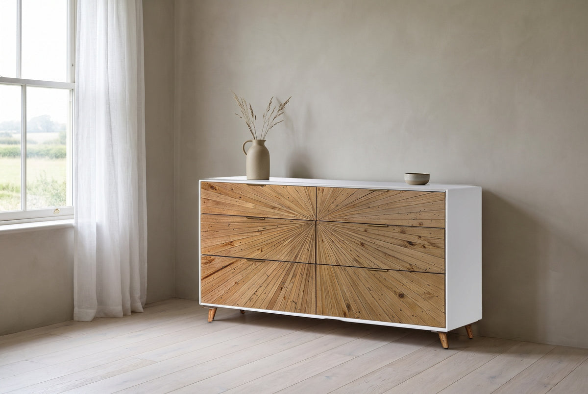 Cesana sunburst dresser against a warm greige plaster wall in a Wolfville, Nova Scotia farmhouse bedroom, fields through the window