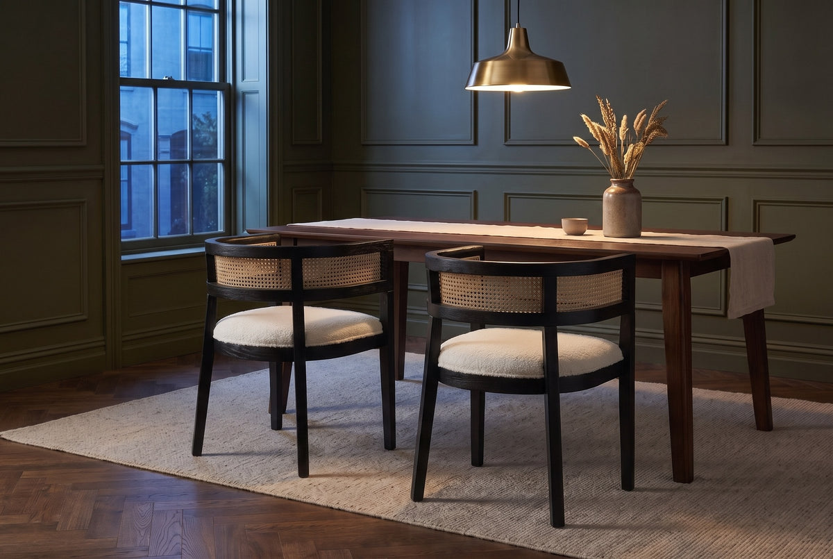 Two Cesena dining chairs in Black at a dark walnut table in an olive-green Toronto dining room at dusk