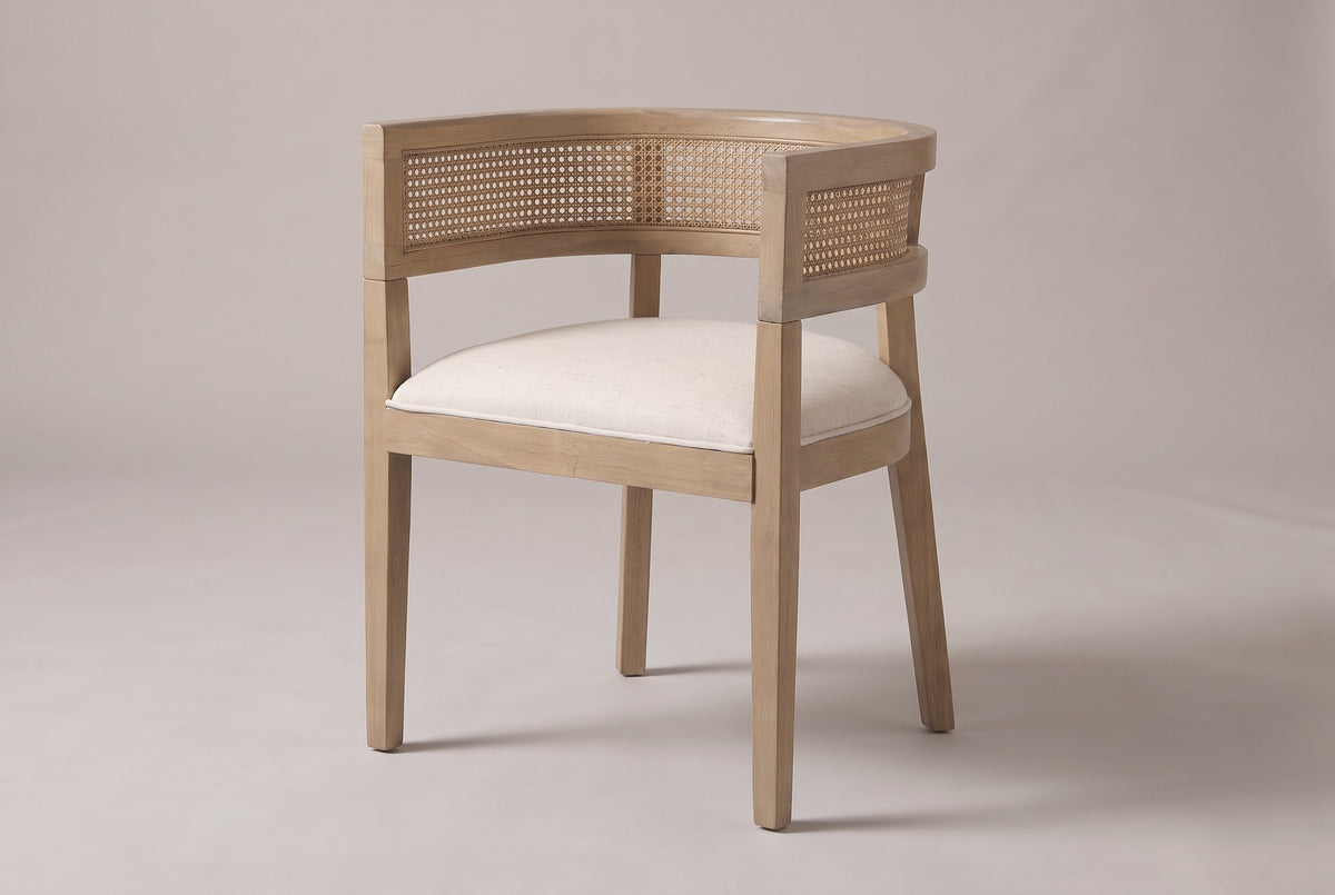 Cesena cane-back dining chair in Natural Ash, three-quarter view on a warm light-grey studio backdrop