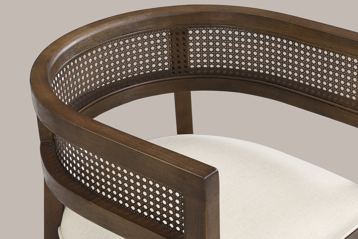 Close-up of the wide curved top rail, the cane-look weave band and the arm of the Walnut Cesena chair
