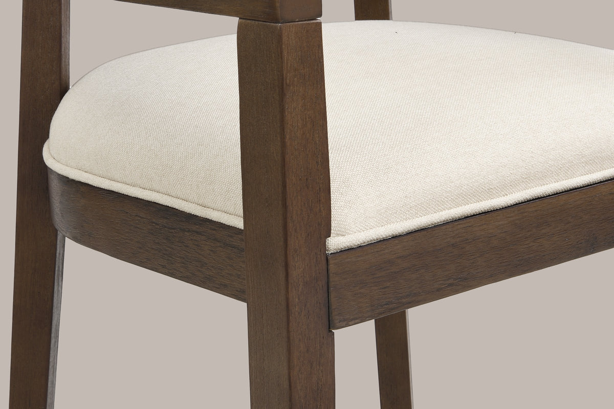 Close-up of the welted linen-look seat, the wood seat frame and a tapered front leg of the Walnut Cesena chair