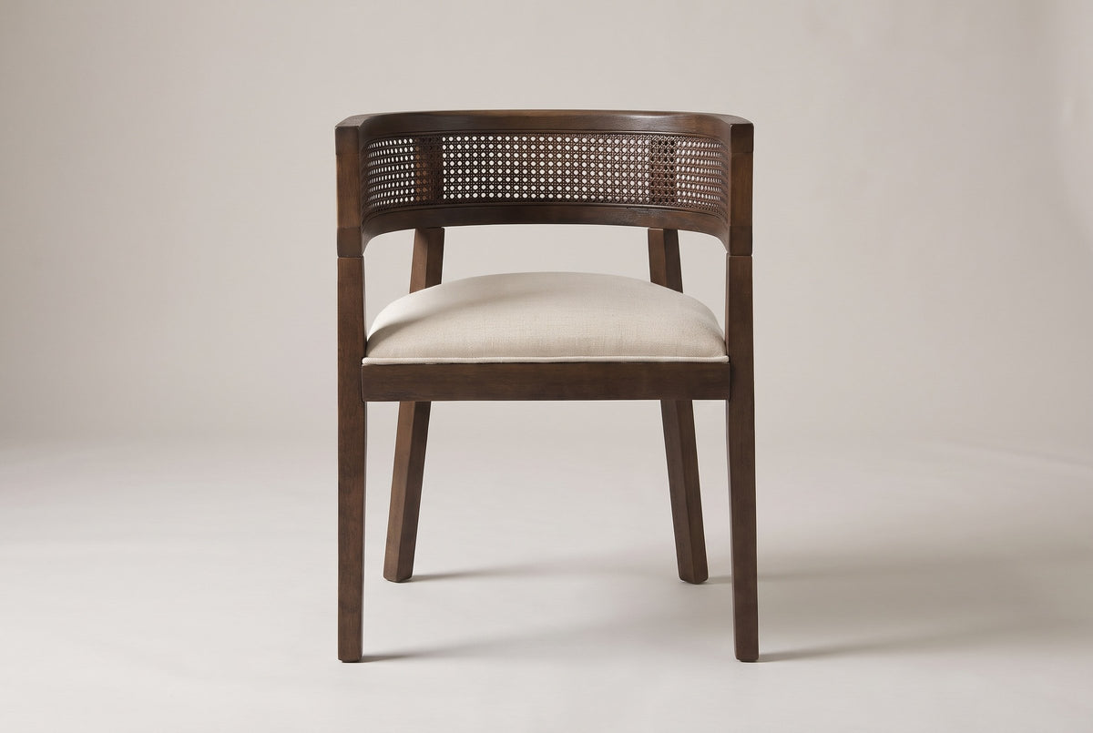 Cesena dining chair in Walnut, straight front view showing the barrel back, the cane-look band and four legs