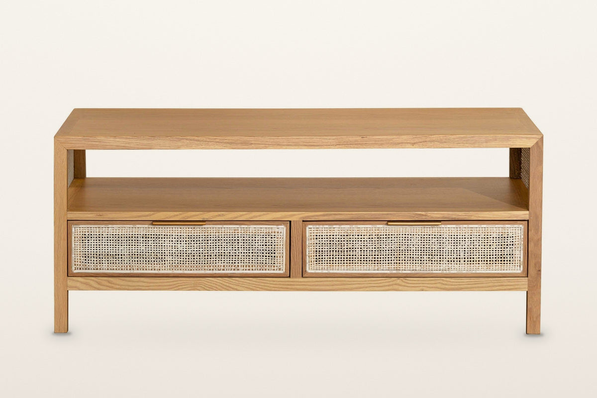 Cetara coffee table in Natural, front view on a warm white studio backdrop: the open shelf over two wicker drawers
