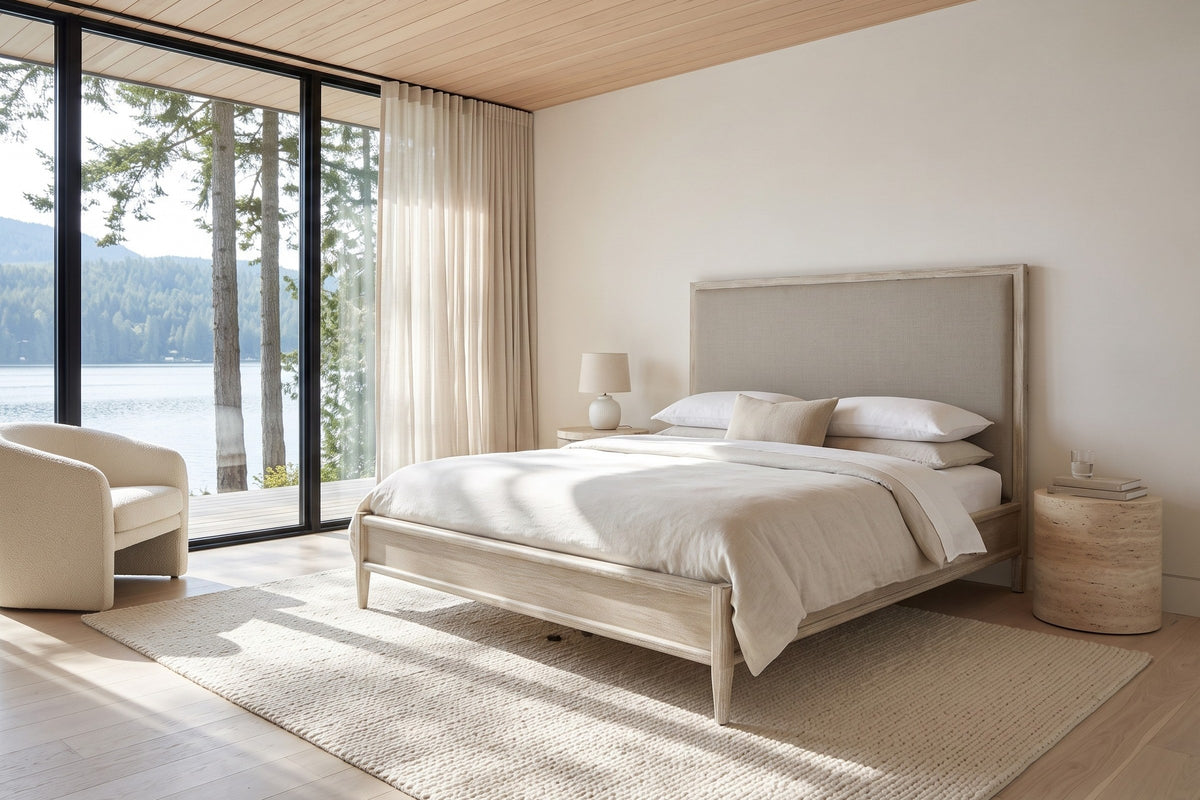 Chiusdino bed in whitewashed wood with a greige linen-look headboard in a bedroom in a Sproat Lake house on Vancouver Island