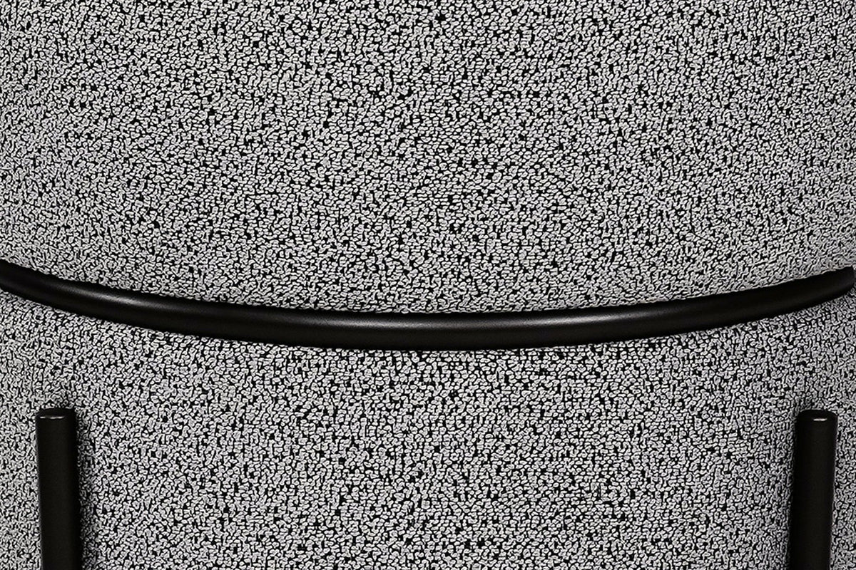 Rear close-up of the Chiusi chair: the boucle back pad above the wrap, the slim steel rail and the two rear leg caps