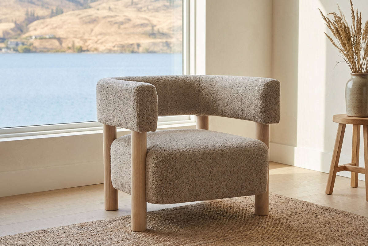 Cingoli chair in a bright Kelowna lake house sitting room with a lake view and a jute rug