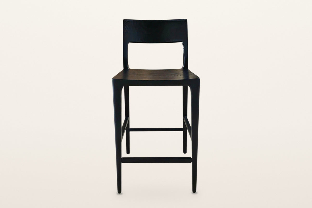 Cison counter stool in Black, straight front view on a warm white studio backdrop