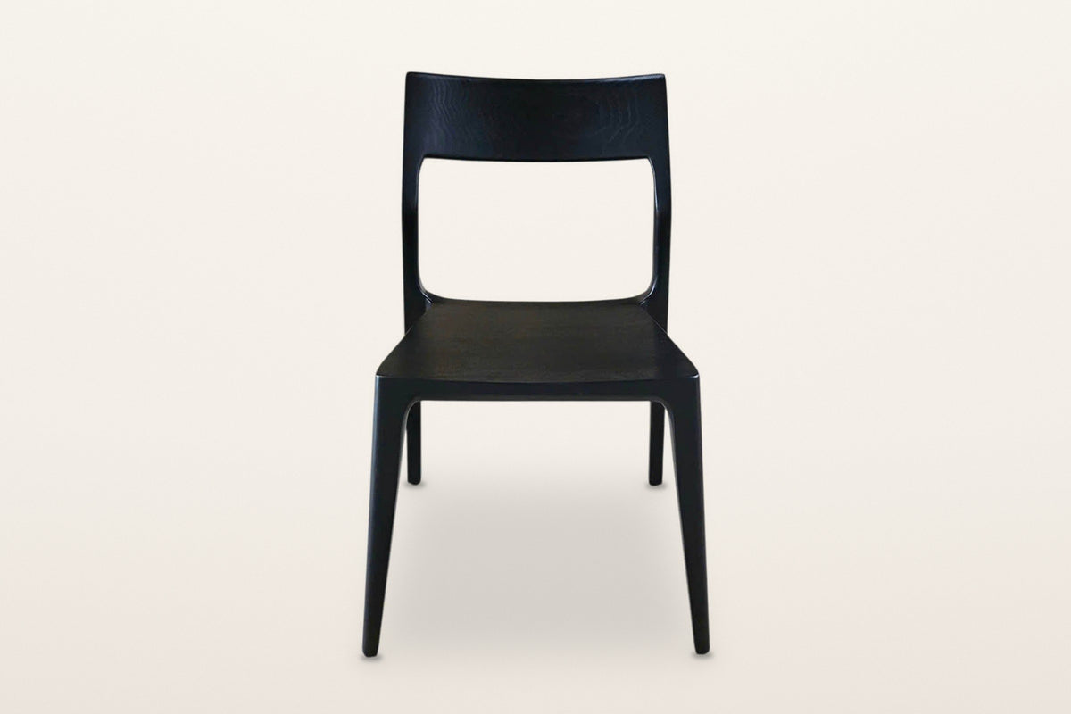 Cison dining chair in Black, front view on a warm white studio backdrop: the wide backrest on top of the posts