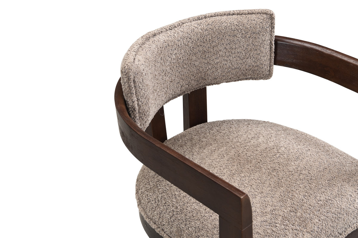 Close-up of the flat espresso arm rail curving round behind the slim light brown boucle back pad of the Cisternino chair