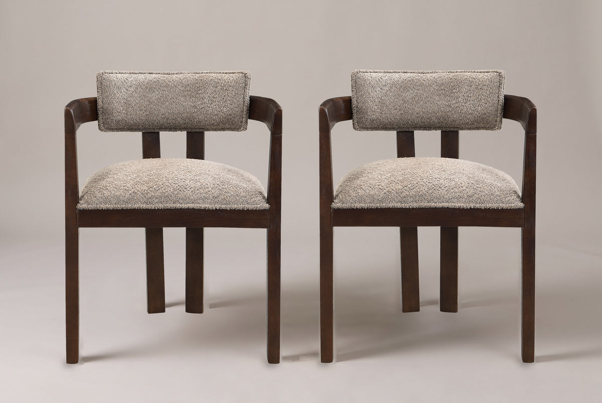 A set of two Cisternino dining armchairs in Espresso with light brown boucle seats, straight front view on a studio backdrop