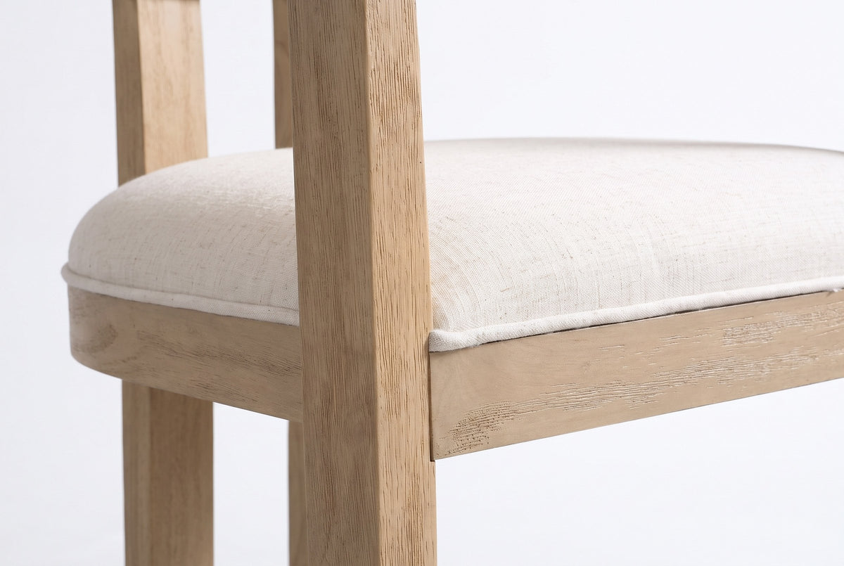 Close-up of the welted linen-look seat, the square front leg and the brushed wood frame of the Cisternino chair