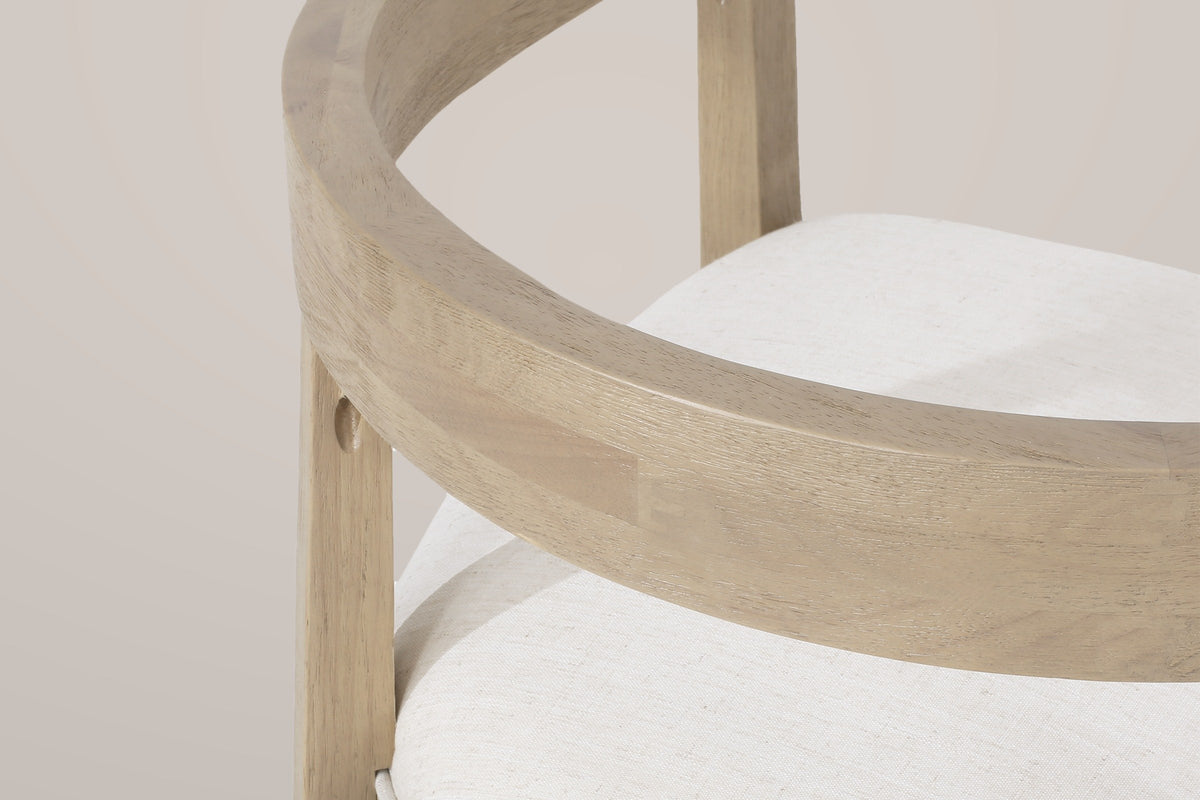 Close-up of the Civita's one continuous curved rail, built from small blocks of wood, beside the linen-look seat