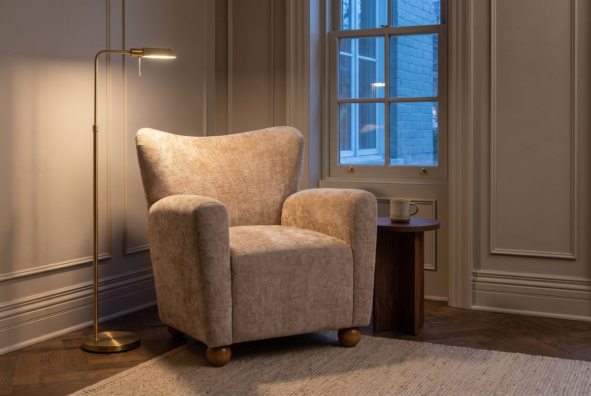 Collodi chair in an Ottawa townhouse reading corner in the evening, a brass floor lamp lit beside it