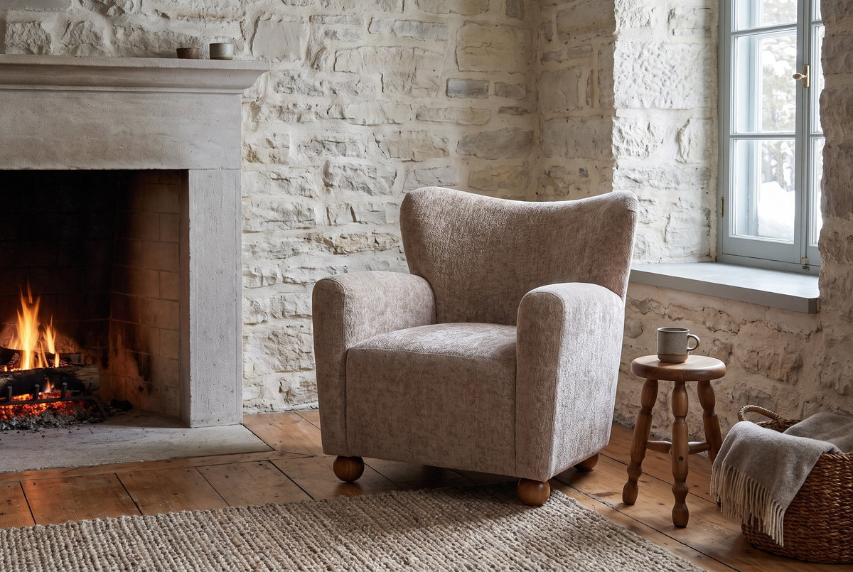 Collodi chair in a Quebec City stone sitting room with a low fire, a turned stool and snowy daylight