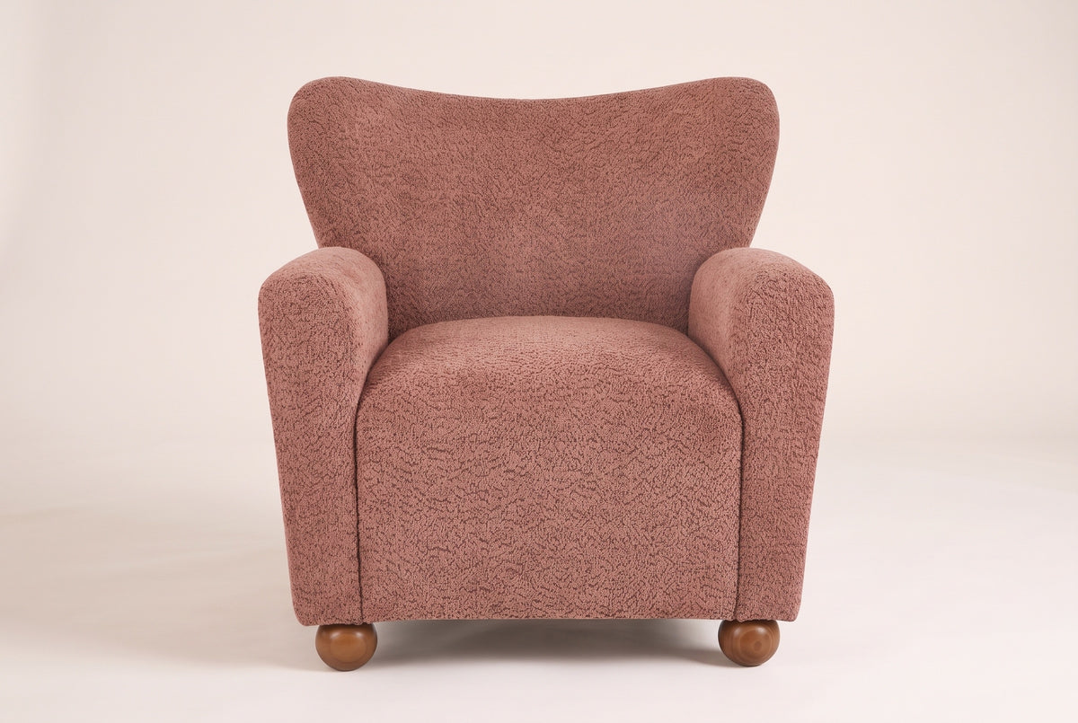 Collodi chair in Coral, straight front view: waved wingback, two round arms, solid wood ball feet