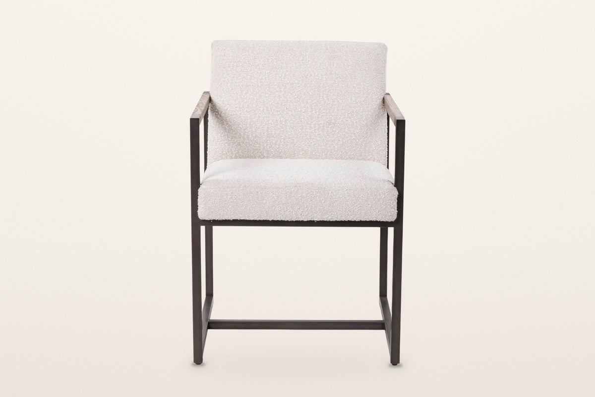 Coreglia dining armchair in White, front view on a warm white studio backdrop: the thick seat flush with the front posts
