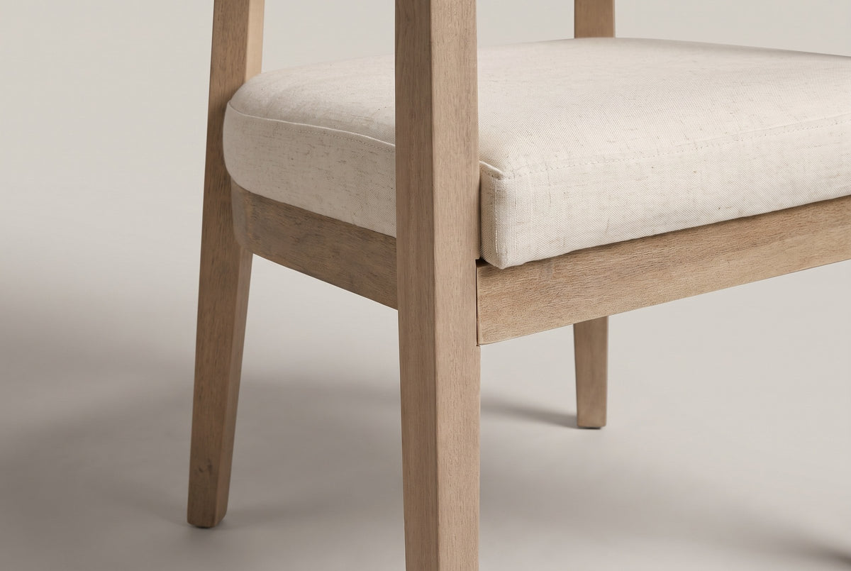 Close-up of the stitched seat edge, the wooden apron and a square tapering leg of the Corinaldo dining chair