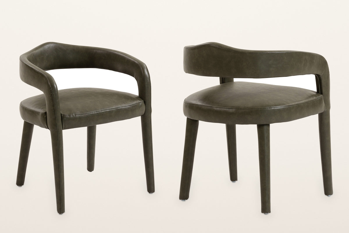 Two Corniglia armchairs in moss faux leather, front and back three-quarter views: the curved back band, the open gap above the seat and the upholstered legs