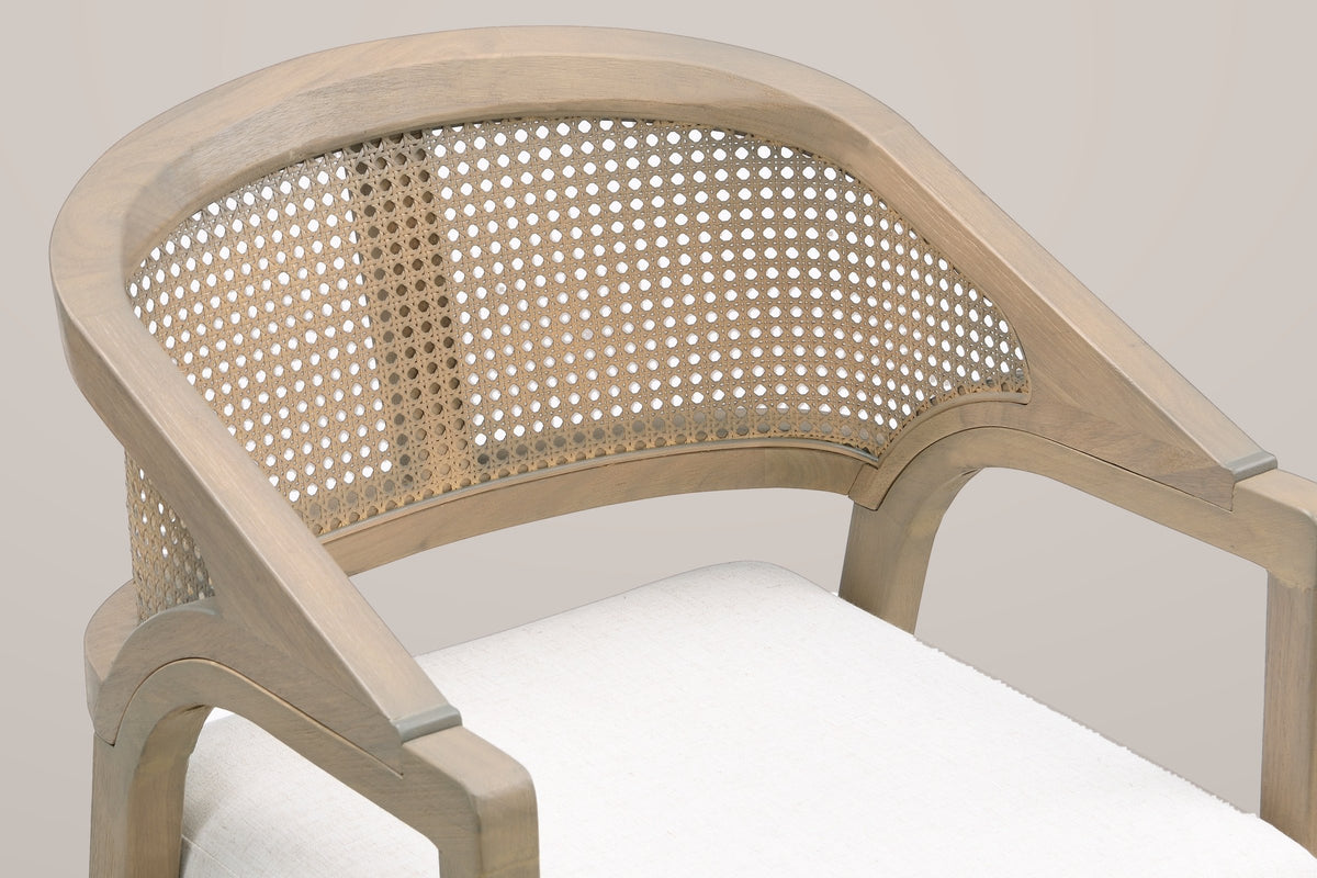 Close-up of the Cortina curved crest rail, the woven cane back panel, the arm bracket and the linen seat cushion