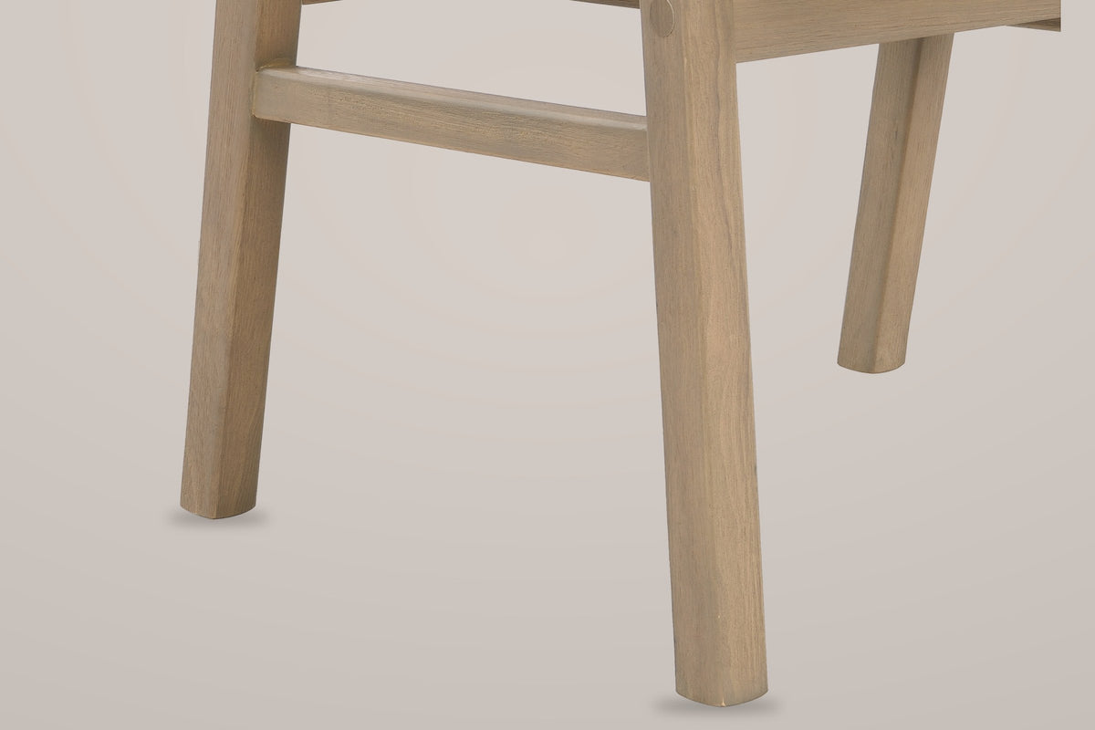 Close-up of a Cortina front leg, the side stretcher and a rear leg in grey-washed light ash solid wood