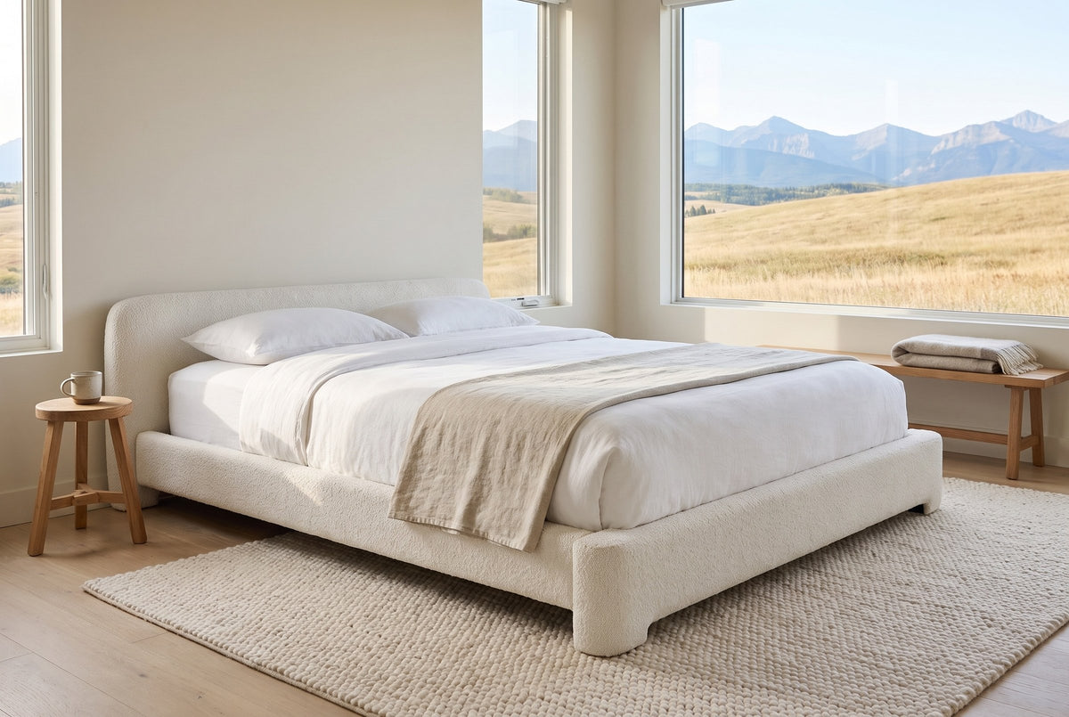 Cupello boucle bed in a foothills bedroom with golden grassland and mountains through the window