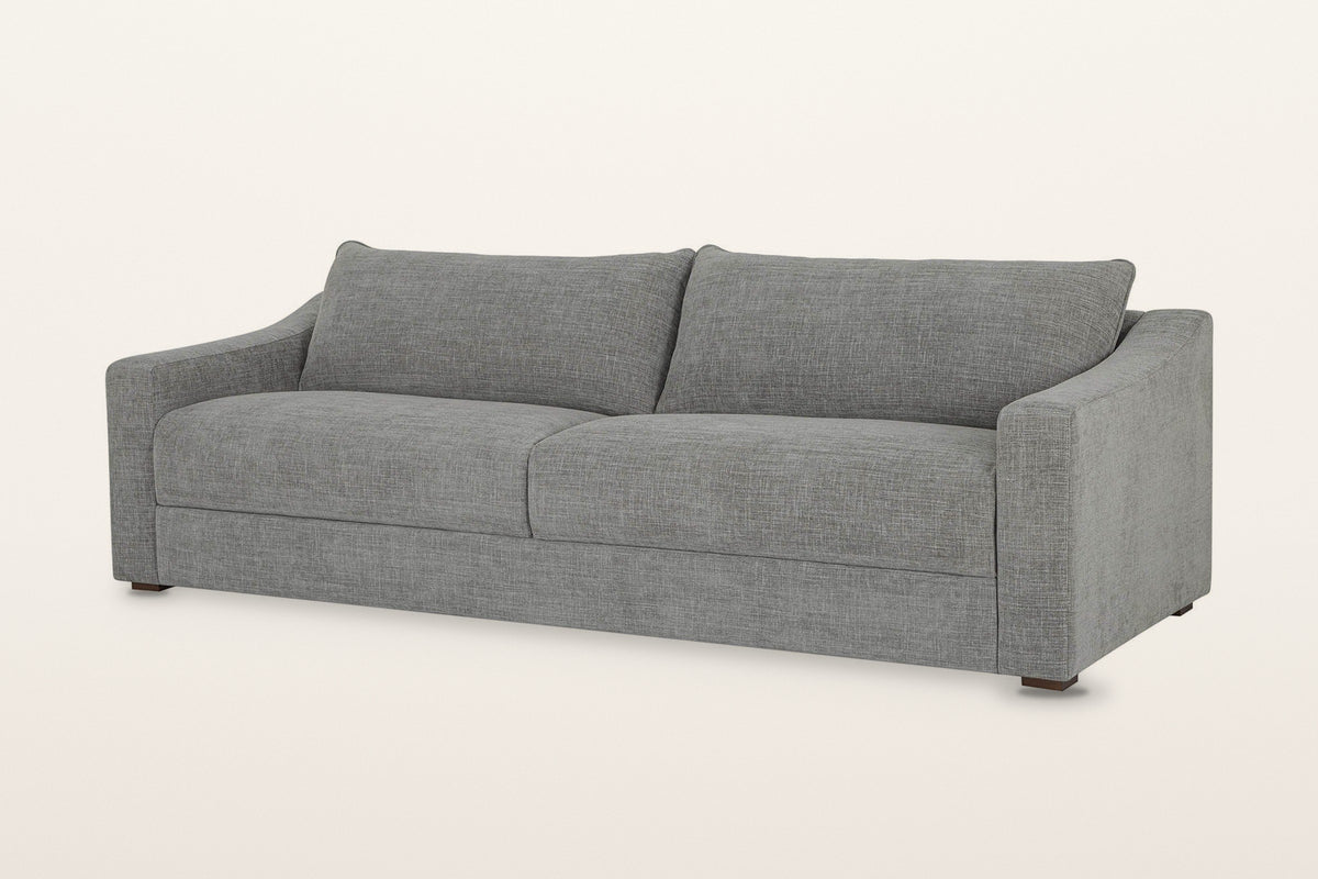 Cupramontana sofa in Grey, three-quarter view on a warm white studio backdrop