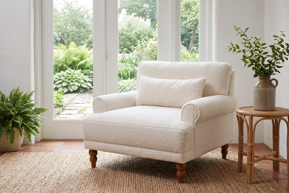 Dolceacqua chair on a jute rug in a Victoria garden room with glass doors onto ferns and a stone path