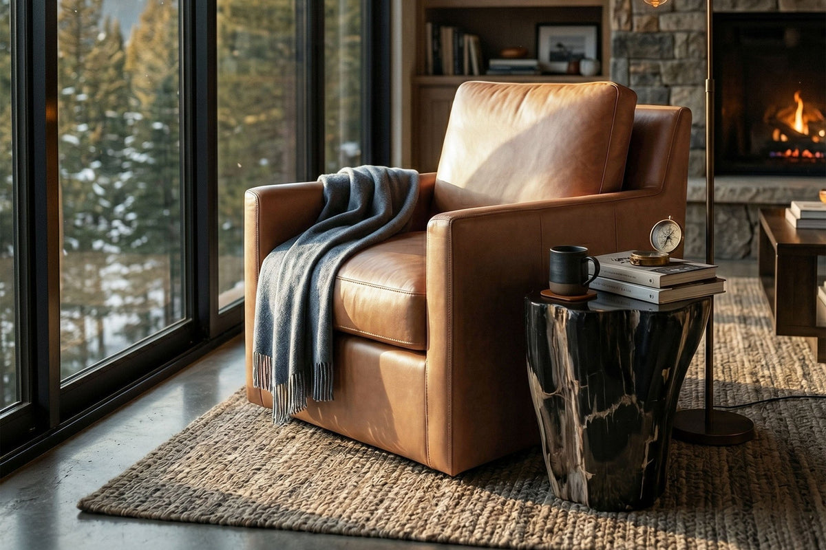 Elwood Latte leather swivel glider chair by tall windows in a cabin-style living room