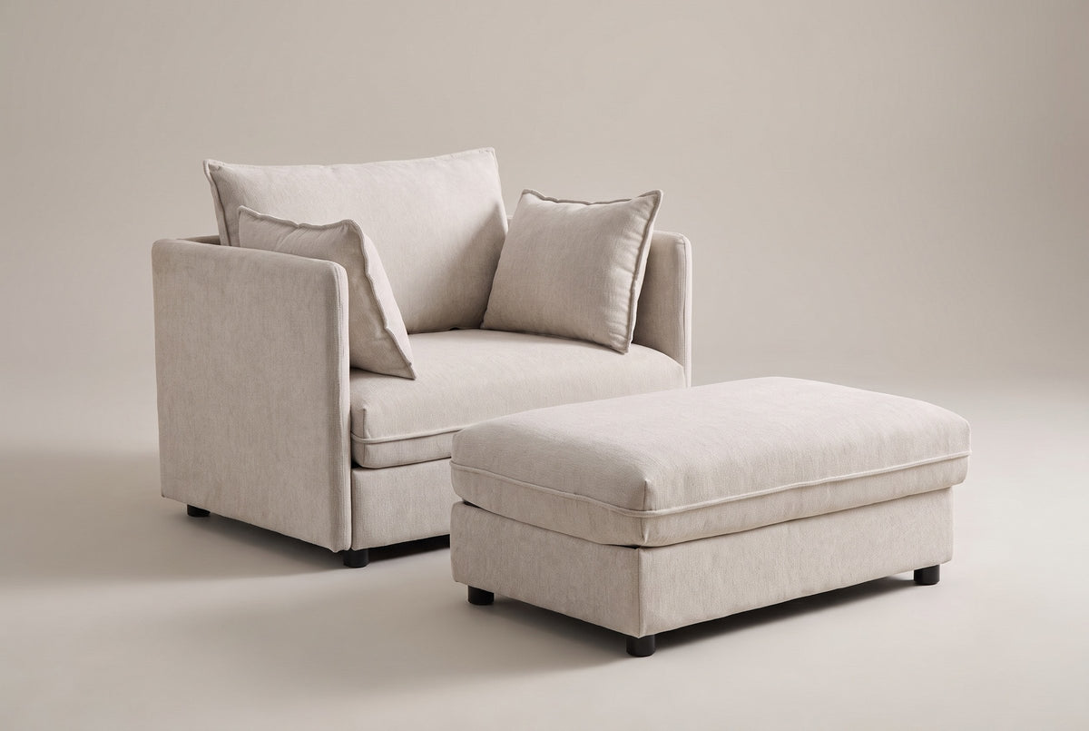 Faenza chair-and-a-half in beige chenille with its storage ottoman, three-quarter view on a warm grey studio backdrop