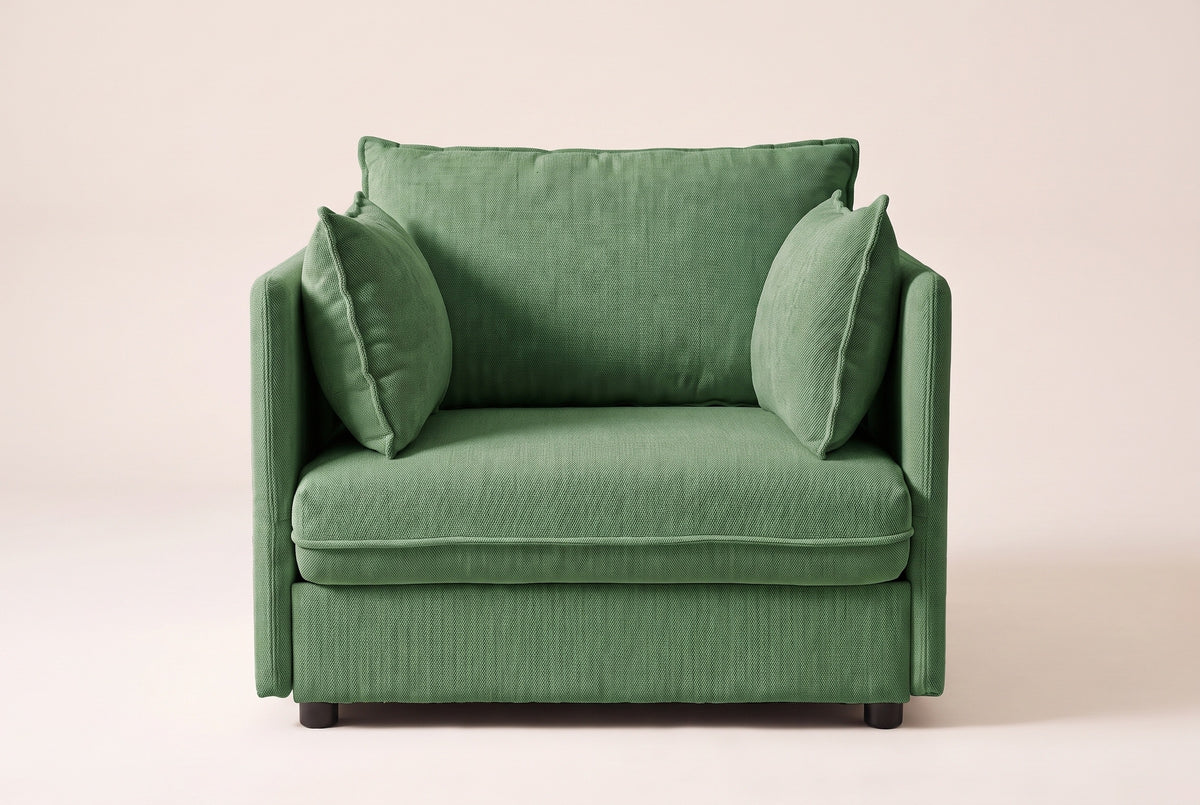 Faenza chair in green chenille, straight front view: slim flat arms, one back cushion and two throw pillows