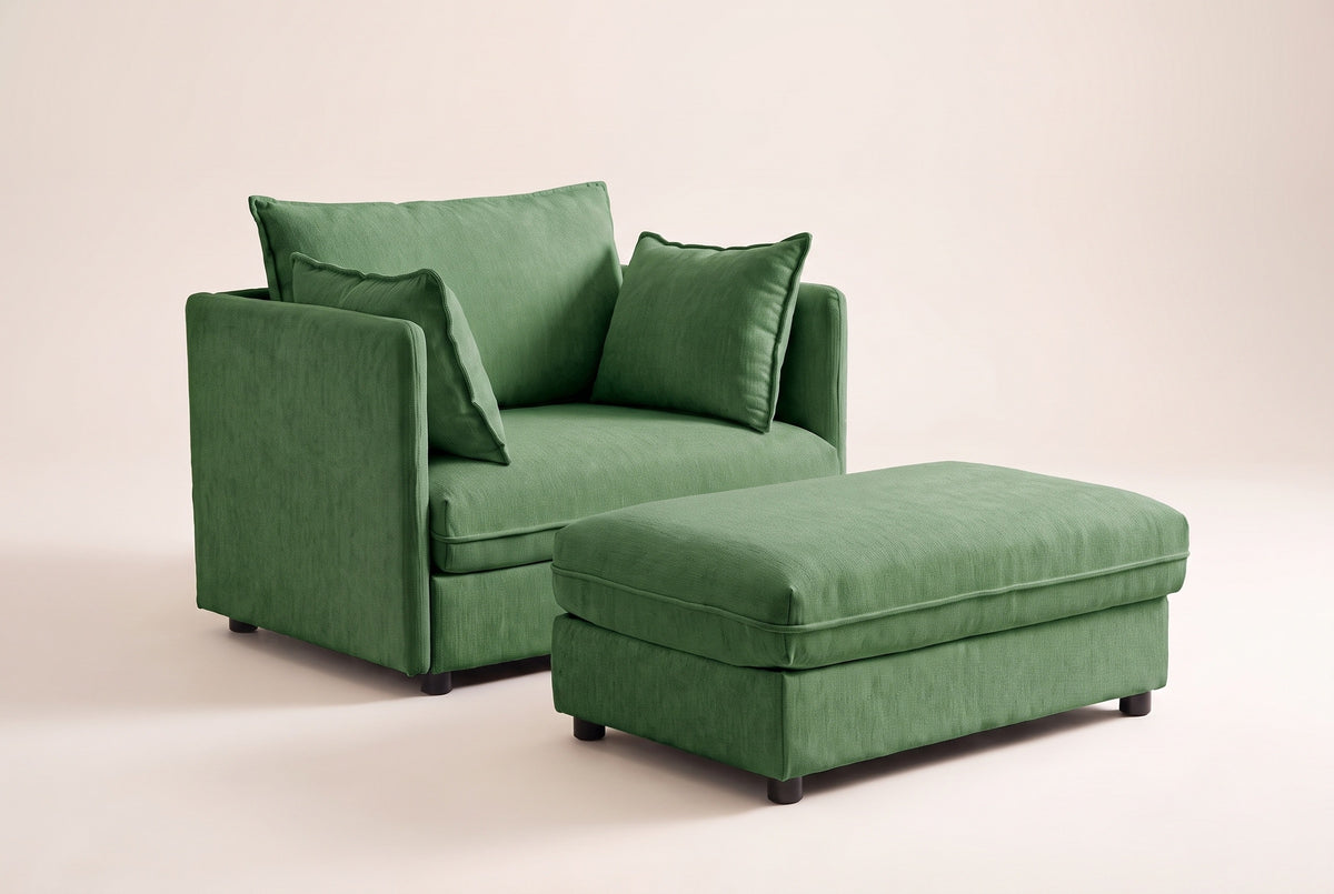 Faenza chair-and-a-half in green chenille with its storage ottoman, three-quarter view on a warm off-white backdrop