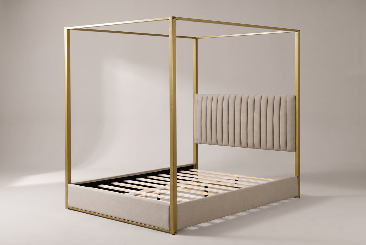 Fermo canopy bed in beige and gold, three-quarter view on a warm grey studio backdrop