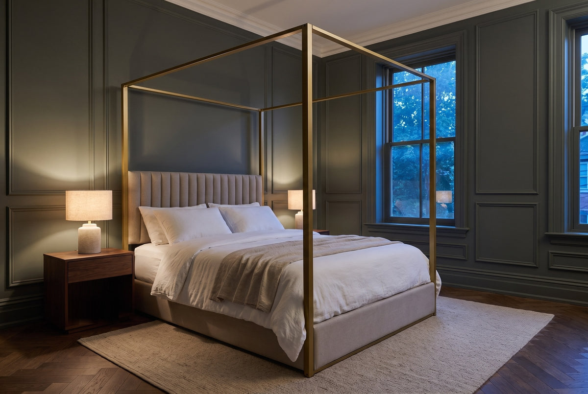 Fermo canopy bed in a dark green panelled bedroom at dusk, a lamp glowing on a walnut nightstand