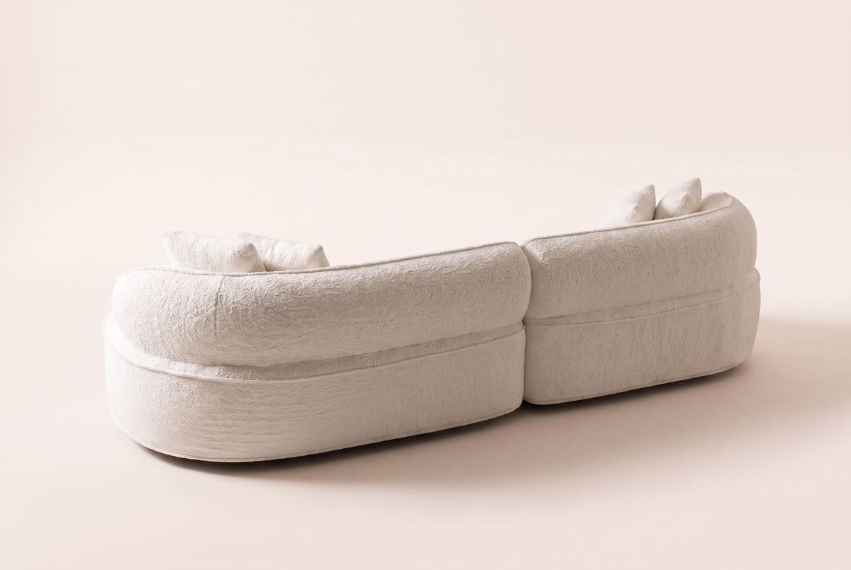 The Fiora curved sofa in White from behind, showing the rounded back