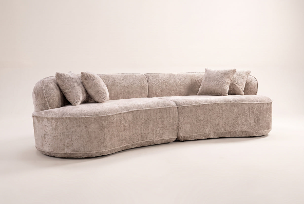 The Fiora curved sofa in Camel from a low front angle