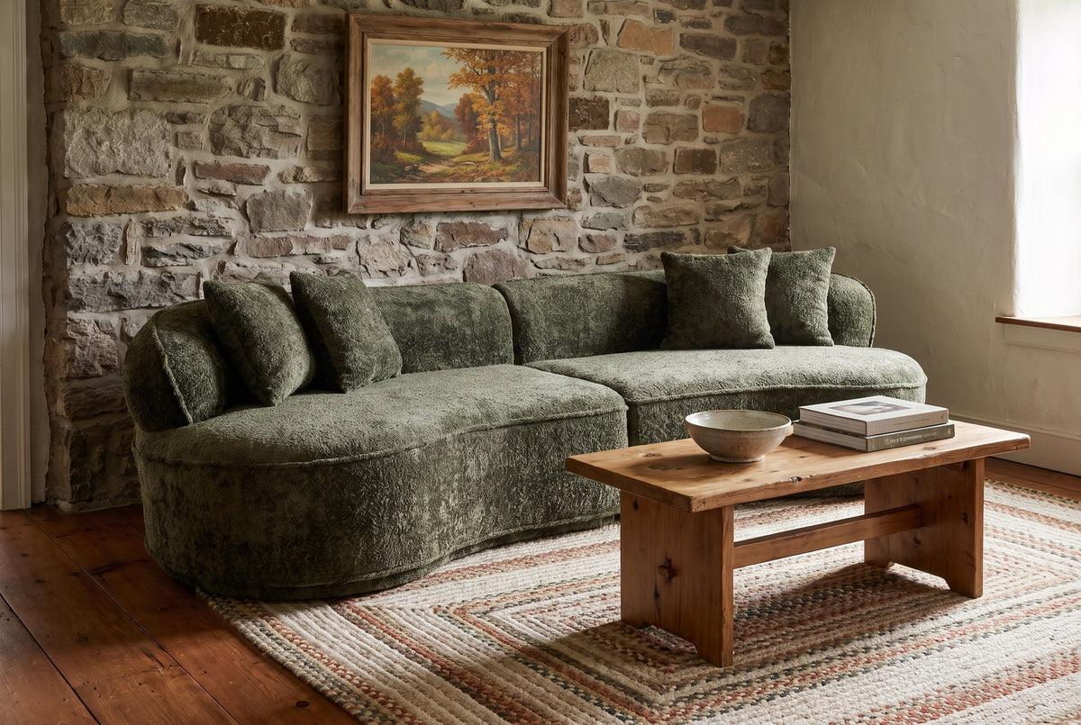 The Fiora sofa in Green in a Catskills stone farmhouse with a braided rug